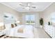 Bright main bedroom features a ceiling fan, sliding glass door, and white furnishings at 7211 Cloister Dr # 101, Sarasota, FL 34231