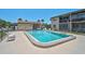 Outdoor pool with condos and a pool house in the background at 7211 Cloister Dr # 101, Sarasota, FL 34231