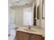Bright bathroom featuring a vanity, toilet, and large mirror reflecting the shower at 7432 Birds Eye Ter, Bradenton, FL 34203