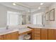 Bathroom featuring double vanity and glass block shower enclosure and soaking tub at 7432 Birds Eye Ter, Bradenton, FL 34203