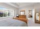 Bedroom featuring large bright window, wooden dresser, and view into adjoining room at 7432 Birds Eye Ter, Bradenton, FL 34203
