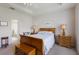 Bright bedroom with wooden furniture, ceiling fan, and view into the bathroom at 7432 Birds Eye Ter, Bradenton, FL 34203