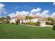 Charming single story home with a well-manicured lawn, tile roof, and attached two-car garage at 7432 Birds Eye Ter, Bradenton, FL 34203