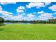 Lush golf course with a scenic lake and players enjoying the sunny day at 7432 Birds Eye Ter, Bradenton, FL 34203