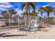 An outdoor hot tub with access lift, next to a white fence and tropical trees at 7432 Birds Eye Ter, Bradenton, FL 34203