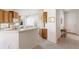 Bright kitchen featuring tile floors, white appliances, wooden cabinets and white countertops at 7432 Birds Eye Ter, Bradenton, FL 34203