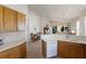 Open kitchen overlooking the living area featuring tile floors, and wooden cabinets at 7432 Birds Eye Ter, Bradenton, FL 34203