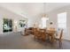 Open-concept living and dining area filled with natural light, showcasing a comfortable and inviting space at 7432 Birds Eye Ter, Bradenton, FL 34203