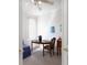 Office with view of chair, blue sofa, side table, and round dining table at 7432 Birds Eye Ter, Bradenton, FL 34203