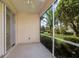 Enclosed patio with ceiling fan overlooking a lush, landscaped backyard at 7432 Birds Eye Ter, Bradenton, FL 34203