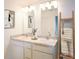 Bright bathroom featuring double sinks with modern fixtures, and decorative accents at 7435 Cape Girardeau St, Englewood, FL 34224