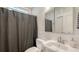 Bathroom with shower curtain, white sink, and vanity at 815 N East Ave, Sarasota, FL 34237