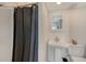 Bathroom with a pedestal sink, white tiles, and a shower with a curtain at 815 N East Ave, Sarasota, FL 34237
