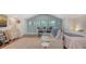 Comfortable bedroom featuring a sitting area, desk, and ample natural light at 815 N East Ave, Sarasota, FL 34237