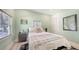 Bedroom with wood floors, blue blanket on bed, and windows at 815 N East Ave, Sarasota, FL 34237