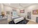 Bedroom with wood floors, ceiling fan, and unique decor on walls at 815 N East Ave, Sarasota, FL 34237