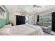 Bedroom with a closet, a sofa, and sliding doors to the backyard patio at 815 N East Ave, Sarasota, FL 34237