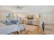 Well-lit bedroom with a bed, seating, desk and kitchen area at 815 N East Ave, Sarasota, FL 34237