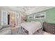 Comfortable bedroom with a ceiling fan, a kitchenette, and an en suite bathroom at 815 N East Ave, Sarasota, FL 34237