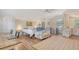 Bright, open bedroom with ample workspace, a full bed, and a cozy sitting area at 815 N East Ave, Sarasota, FL 34237