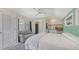 Sunlit bedroom with a gray sofa, kitchenette, and a door leading to the backyard at 815 N East Ave, Sarasota, FL 34237