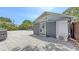 Backyard studio with sliding barn doors and a concrete-tiled patio at 815 N East Ave, Sarasota, FL 34237