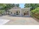 Attractive exterior showcasing a charming home with a welcoming front porch and a convenient carport for parking at 815 N East Ave, Sarasota, FL 34237