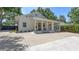 Charming exterior of a well-maintained single-story home with a welcoming front porch and ample parking space at 815 N East Ave, Sarasota, FL 34237