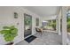 Close-up of a quaint front porch with stylish seating, a welcoming wreath, and a 'welcome' door mat at 815 N East Ave, Sarasota, FL 34237