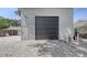 Exterior of a garage with a large roll-up door and a standard entry door, set on a paved area at 815 N East Ave, Sarasota, FL 34237