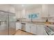 Bright kitchen features granite counters, stainless appliances, and white cabinets at 815 N East Ave, Sarasota, FL 34237