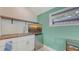Kitchenette area with a small fridge, sink, and a wall-mounted TV at 815 N East Ave, Sarasota, FL 34237