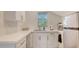 Bright kitchenette with stainless steel appliances, white cabinets, and countertop, plus a window for natural light at 815 N East Ave, Sarasota, FL 34237