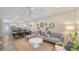 Bright living room with modern decor, a cozy sectional, and seamless flow to the open kitchen and dining area at 815 N East Ave, Sarasota, FL 34237