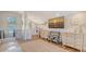 Open-concept living area features hardwood floors, a kitchenette, and a large television at 815 N East Ave, Sarasota, FL 34237