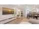 Cozy living room with a modern entertainment center, comfortable seating, and an open layout to the kitchen and dining space at 815 N East Ave, Sarasota, FL 34237
