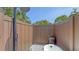Private outdoor shower area with wood-look paneling and a clawfoot tub at 815 N East Ave, Sarasota, FL 34237