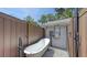 Outdoor shower and freestanding tub with privacy fence and convenient access to the house at 815 N East Ave, Sarasota, FL 34237