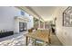 Charming covered patio with a wood table, chairs, and access to the home's entrance at 815 N East Ave, Sarasota, FL 34237