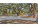 Community playground shaded by mature trees, with colorful play equipment at 815 N East Ave, Sarasota, FL 34237