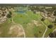 Picturesque aerial view of the community showcasing ponds, walking paths, and lush green spaces at 1111 Harefield Cir, Sun City Center, FL 33573