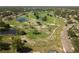 Aerial view featuring a well-kept community with scenic walking paths, ponds and green spaces at 1111 Harefield Cir, Sun City Center, FL 33573