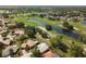 Scenic aerial view showcasing a beautiful community with lush greenery and a tranquil pond at 1111 Harefield Cir, Sun City Center, FL 33573