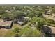 Lovely neighborhood aerial view with mature trees, green lawns, and well-maintained homes at 1111 Harefield Cir, Sun City Center, FL 33573