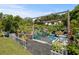 Relaxing backyard patio featuring comfortable seating, lush greenery, and a shaded pergola at 1111 Harefield Cir, Sun City Center, FL 33573