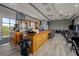 Spacious bar and event space featuring a large television and ample seating at 1111 Harefield Cir, Sun City Center, FL 33573