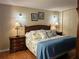 Comfortable bedroom with a plush bed and well-placed sconce lighting at 1111 Harefield Cir, Sun City Center, FL 33573