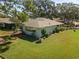 Home exterior featuring lush landscaping, mature trees, and serene outdoor space, offering privacy at 1111 Harefield Cir, Sun City Center, FL 33573