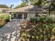 Charming home with covered front porch, inviting entrance, and well-maintained landscaping at 1111 Harefield Cir, Sun City Center, FL 33573