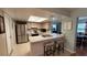Bright kitchen features a breakfast bar, stainless steel appliances, and a tile backsplash at 1111 Harefield Cir, Sun City Center, FL 33573